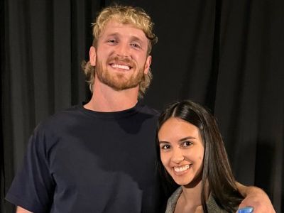 Logan Paul is side hugging Caryn Marjorie as they are posing for the picture.